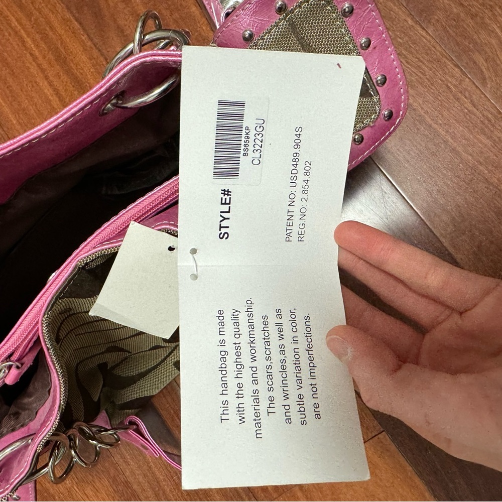 This is a conceal carry bag, pink and looks like any other coach bag.